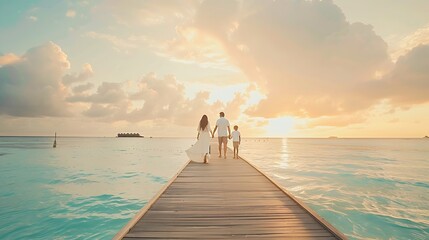 Fototapeta premium A family in white summer clothes walks holding hands over a wooden pier towards a tropical island in the Maldives during sunset time : Generative AI