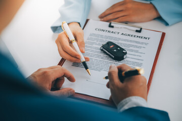 Insurance officers hand over the car keys after the tenant. have signed an auto insurance document...