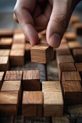 close-up hand stacks wooden cubes. Selective focus