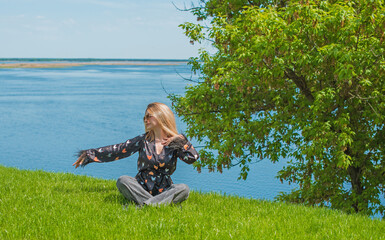 Energy healing and meditation concept, woman on a grass chilling and resting outside
