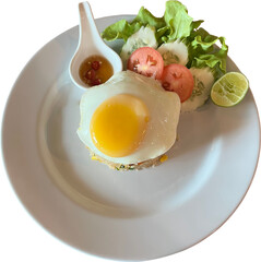 Thai breakfast. Fried rice topped with fried eggs and eaten with vegetables and fish sauce chili on a white background.