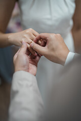 bride and groom holding hands with engagement diamond ring on the bride hand.	
