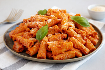 Homemade Vodka Rigatoni Pasta with Parmesan and Basil, side view.