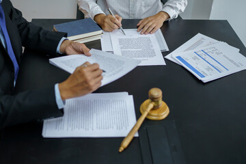 Legal counsel presents to the client a signed contract with gavel and legal law. justice and lawyer...