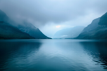 A calm lake surrounded by mountains, misty sky, with a blue color palette, in high resolution photography, with very detailed style