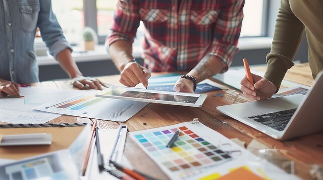 two colleagues interior designer discussing data and digital tablet and computer laptop with sample material and graphics design diagram on wooden desk as concept : Generative AI