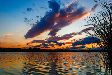 sunset over the lake and dramatic clouds in the sky