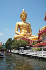 Big Golden Buddha Statue in Wat Pak Nam Phasi Charoen or Pak Nam Temple - It is famous for its large seated Buddha that is the largest in Bangkok Thailand - Travel Sculpture and Architecture Religion 