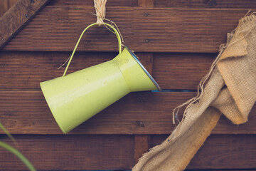 nostalgic green jug on a wooden wall