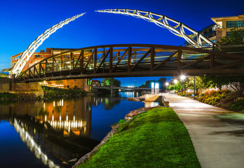Sioux Falls Downtown River Greenway Lighted Trail, Skyline, Bridges, and Reflectoins on the Big Sioux River Water at Night in South Dakota, USA