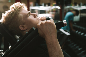 Selective focus on male athletes hand holding onto hack squat machine handle © mad_production