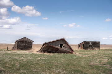 Fototapeta premium Abandoned farm buildings in rural Alberta.
