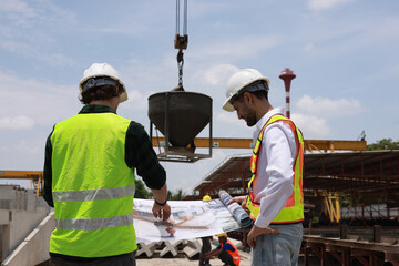 Civil and construction engineers are working on a blueprint drawing with precision to guarantee a...