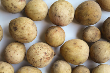 Fruit of Lansium domesticum var duku, known as duku, or langsat, or lanzones, isolated on white background