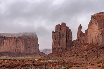 Monument Valley Mountain Ridge formations during a rainy day shows an eerie look to these eroded...
