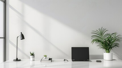 A white desk with a laptop, a potted plant, and a lamp