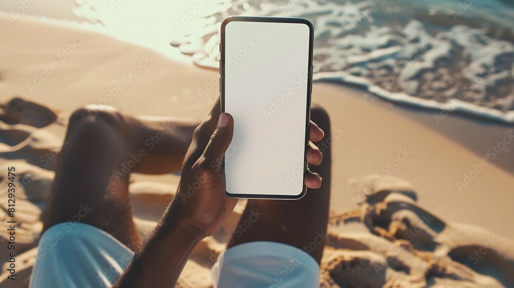 Aufkleber Mockup image of a man holding mobile phone with blank desktop screen while sitting on the beach : Generative AI