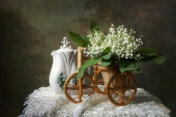 Still life with bouquet  lily of the valley on table