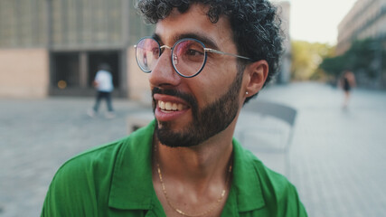 Nice brunette guy with beard, dressed in green shirt, talking to someone