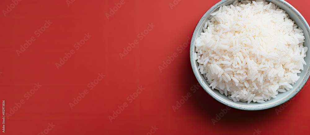 Poster top view of a bowl of boiled rice on a colorful background providing ample space for text in the ima
