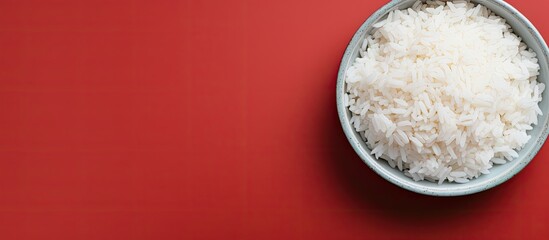 Top view of a bowl of boiled rice on a colorful background providing ample space for text in the...