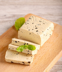 Basil tofu, sliced on  board