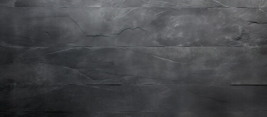 Naklejka premium Top view of a textured background in dark grey or black slate providing ample copy space for an image