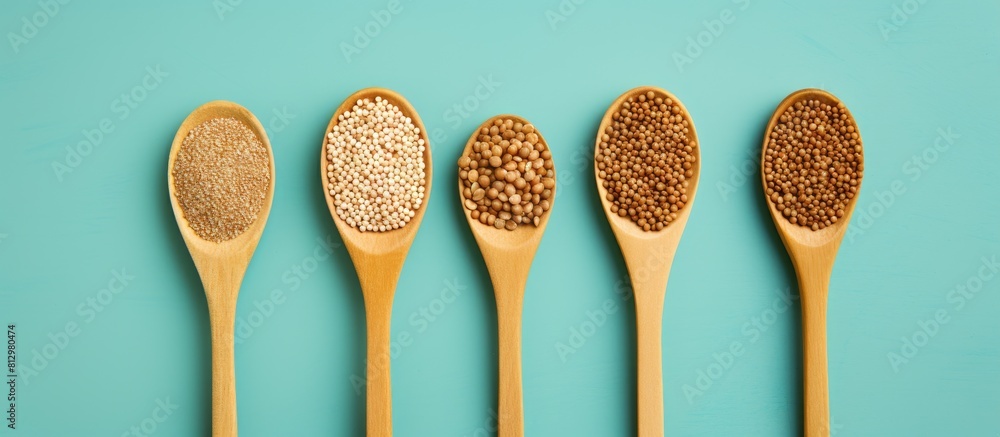 Poster a top down view of a wooden spoon filled with sprouted buckwheat surrounded by fresh green leaves on