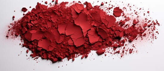 Red eye shadow crumbled creating a textured appearance It is captured in a copy space image against a white background