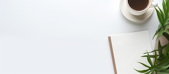 Top view of a freelancer s workspace with a copy space image It depicts a comfortable work from home setup for online work and studying The composition includes a notepad stationery and is laid on a