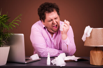 Colds and illness. Manager with a runny nose at the workplace.