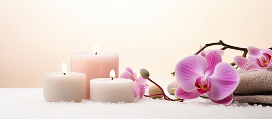 A white background hosts a top view of various spa accessories such as candles towels salt and orchids These elements bring forth images of spa salons therapeutic treatments and indulgent beauty ritu