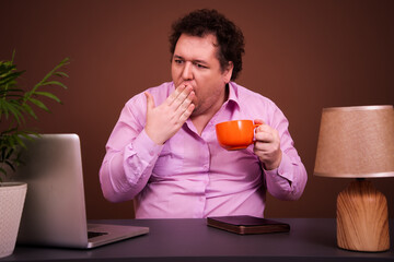 Funny man watching movies on laptop at home. Brown background.