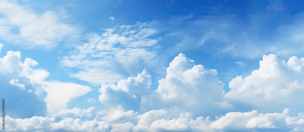 Poster vast blue sky with clouds as a background providing ample copy space image