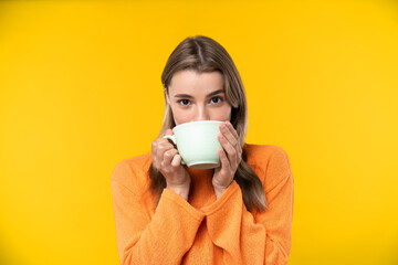 Happy emotions concept. Positive and beautiful young woman in studio cup of coffee