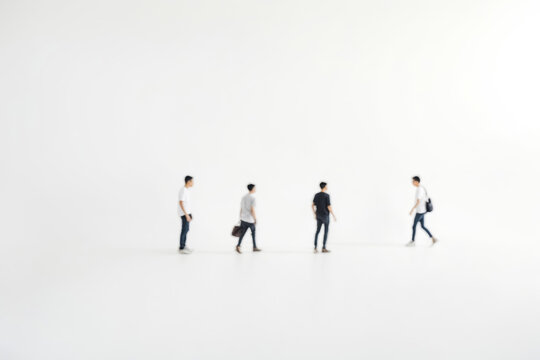 Silhouetted Figures Walking Across a White Background