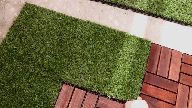 Wooden tiles and artificial grass combine to create a beautiful covering for outdoor floors on balconies and terraces. Laying wooden tiles on the balcony floor.