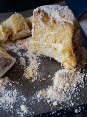 A sliced cake on a black plate
