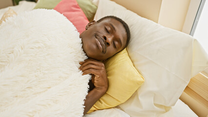African american man sleeping peacefully in a cozy indoor bedroom setting, covered with a white...