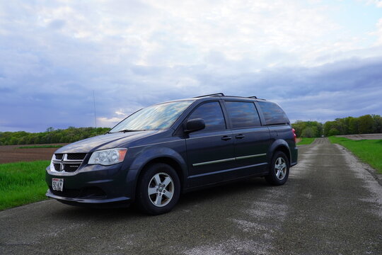 Dark Gray 2012 Dodge Grand Caravan parked in a nature setting.