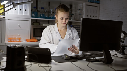 Focused young caucasian woman scientist analyzing paperwork in a modern laboratory