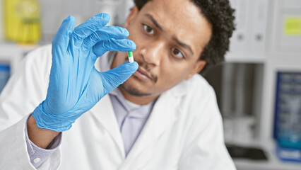 Focused man examining medication in laboratory