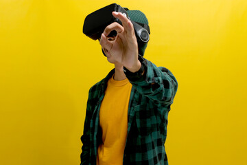 Asian man wearing a VR headset smiles and gives an okay gesture, seemingly enjoying exploring...