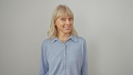 Portrait of a smiling young caucasian woman with blonde hair in a blue shirt against a white background.