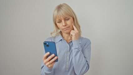 Pensive caucasian woman using smartphone against white background