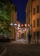 Street of the night city of Luxembourg with glowing laterns