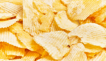 A close-up view of crispy, golden potato chips displaying texture and snack appeal.