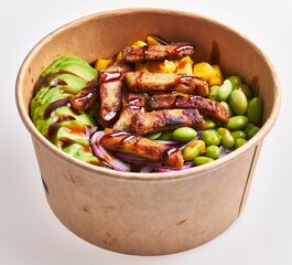 A freshly prepared poke bowl featuring succulent chicken, ripe avocado, sweet mango, edamame beans, red onion, and sauce in a paper container.