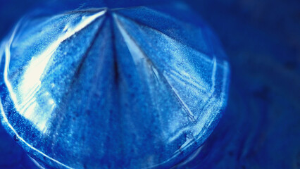 Shiny sapphire. Glitter paint. Reflective liquid. Defocused blue color diamond sparkling luminous...