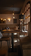 Warmly lit upscale cafe interior featuring elegant wooden furniture and cozy ambiance.